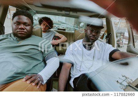 Biracial brutal band sitting in old car, they on road trip 117882660