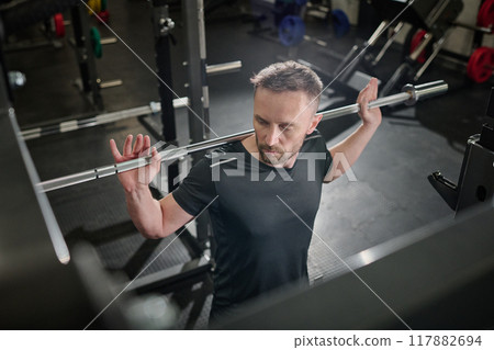 High angle shot of sportsman working out with free weights 117882694