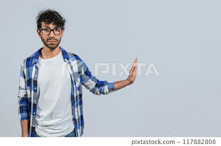 Displeased young man rejecting with rejection gesture, throw palms isolated. Displeased person with rejection gesture isolated, pulls palms in rejection, frowns in disgust Displeased young man rejecting with rejection gesture, throw palms isolated. Displeased person with rejection gesture isolated, pulls palms in rejection, frowns in disgust 117882808