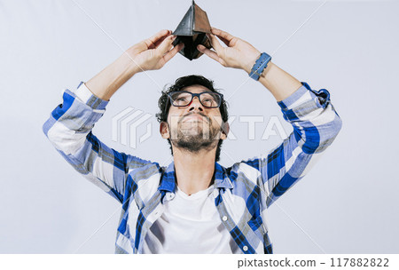 Sad man shaking an empty wallet. Sad person shaking an empty wallet. Man with financial problems shaking wallet. Moneyless frustrated person concept. Sad man shaking an empty wallet. Sad person shaking an empty wallet. Man with financial problems shaking wallet. Moneyless frustrated person concept. 117882822