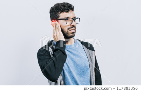 Person with ear pain, on isolated background, Suffering man massaging his ear isolated, concept of person with otitis and tinnitus Person with ear pain, on isolated background, Suffering man massaging his ear isolated, concept of person with otitis and tinnitus 117883356
