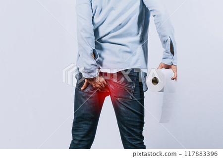Man with toilet paper in hand touching his buttock, Man with diarrhea problem, man with hemorrhoid problem on isolated background Man with toilet paper in hand touching his buttock, Man with diarrhea problem, man with hemorrhoid problem on isolated background 117883396