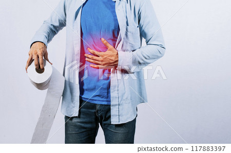 Man with stomach problems holding toilet paper, Person with toilet paper with stomach problems on isolated background, Concept of a person with digestive problems 117883397