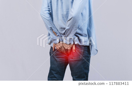 Man with digestive problem touching his buttock, man with hemorrhoid problem on isolated background, Man with diarrhea problem 117883411