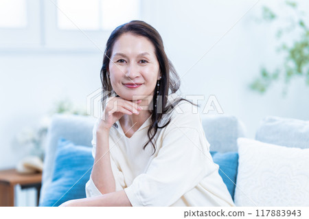 A stylish senior woman relaxing on the sofa A stylish senior woman relaxing on the sofa 117883943