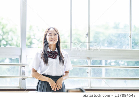Portrait of a high school girl by the window in the classroom Portrait of a high school girl by the window in the classroom 117884542