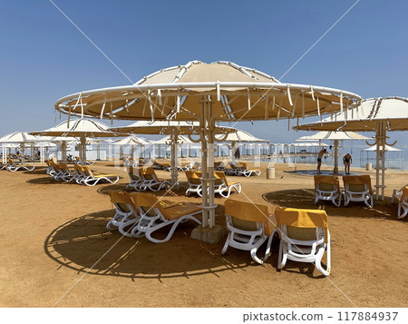 Beach umbrella on the shore of the Dead Sea Beach umbrella on the shore of the Dead Sea 117884937