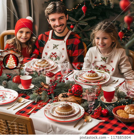 A family is sitting at a table with a Christmas tree in the background 117885804
