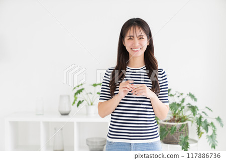 一個年輕的女人在房間裡放鬆 一個年輕的女人在房間裡放鬆 117886736