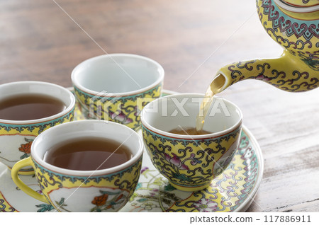 將烏龍茶倒入中國茶具中 將烏龍茶倒入中國茶具中 117886911