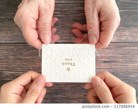 Handing a message card to an elderly woman 117886934