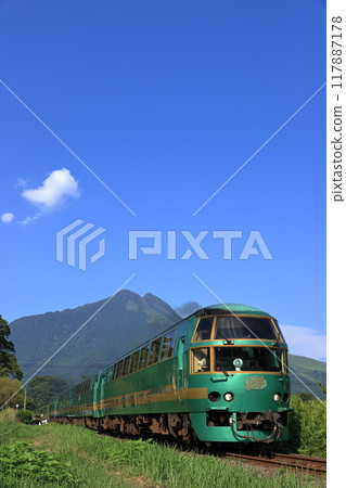 The Yufuin no Mori Express train running on the Kyudai Main Line with Mount Yufu in the background The Yufuin no Mori Express train running on the Kyudai Main Line with Mount Yufu in the background 117887178