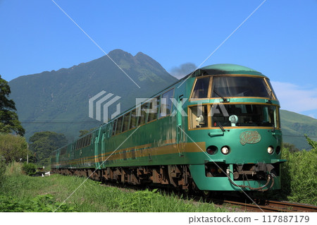 The Yufuin no Mori Express train running on the Kyudai Main Line with Mount Yufu in the background 117887179
