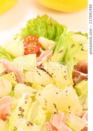 Tosa Buntan, prosciutto and avocado salad. Large citrus fruits. Light background. Tosa Buntan, prosciutto and avocado salad. Large citrus fruits. Light background. 117891490