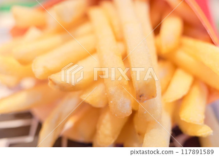 French fries popping out of a container at a fast food restaurant French fries popping out of a container at a fast food restaurant 117891589