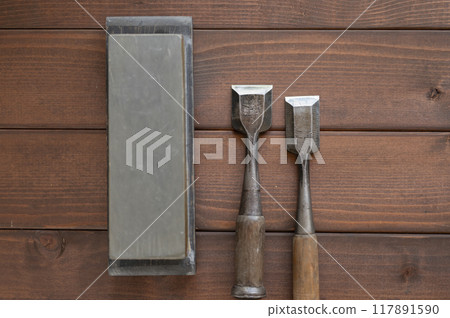 A well-used chisel and natural whetstone A well-used chisel and natural whetstone 117891590
