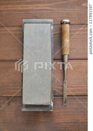 A well-used chisel and natural whetstone A well-used chisel and natural whetstone 117891597