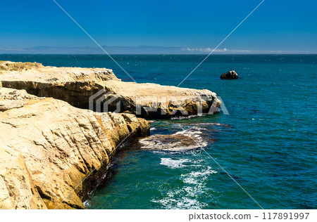 Rocky Ocean Cliffside with Clear Blue Water in Santa Cruz - California, United States Rocky Ocean Cliffside with Clear Blue Water in Santa Cruz - California, United States 117891997