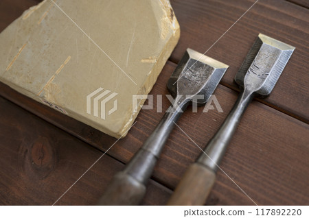 A well-used chisel and natural whetstone A well-used chisel and natural whetstone 117892220