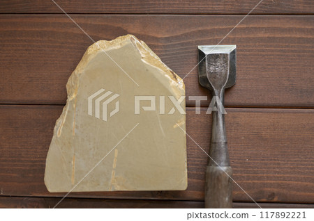 A well-used chisel and natural whetstone A well-used chisel and natural whetstone 117892221