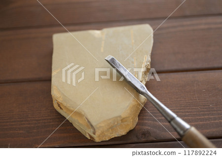 A well-used chisel and natural whetstone A well-used chisel and natural whetstone 117892224