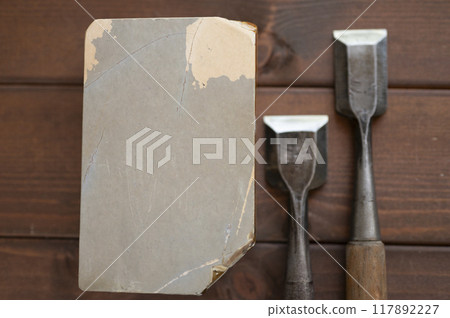 A well-used chisel and natural whetstone A well-used chisel and natural whetstone 117892227