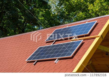 Solar panel on the roof of the house. Red tiles. Solar panel on the roof of the house. Red tiles. 117892316