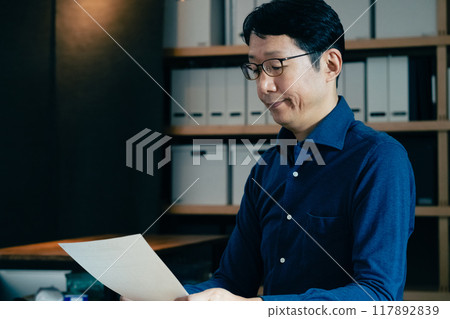 A man filling out an inheritance tax return 117892839