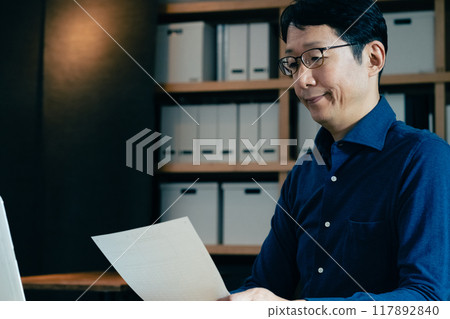 A man filling out an inheritance tax return 117892840