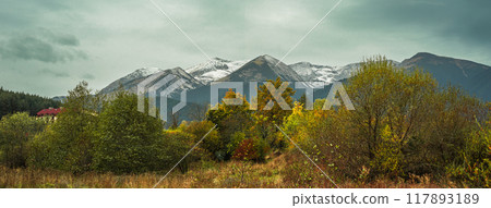 Bansko, Bulgaria, autumn landscape with colorful trees and peaks of the Pirin mountains Bansko, Bulgaria, autumn landscape with colorful trees and peaks of the Pirin mountains 117893189