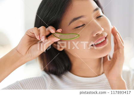 Natural Beauty Treatment. Woman Enjoying Skincare Using Fresh Aloe Vera  117893417