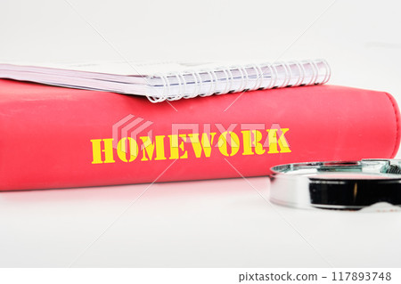 Word HOMEWORK on the end of a business book, notebook on a white background Word HOMEWORK on the end of a business book, notebook on a white background 117893748