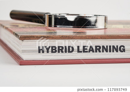 Business, educational and hybrid learning concept, copy space. Concept words HYBRID LEARNING on the end of the book in close-up Business, educational and hybrid learning concept, copy space. Concept words HYBRID LEARNING on the end of the book in close-up 117893749