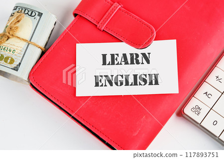 Learn English Text written on a business card on a red business book on a white background 117893751