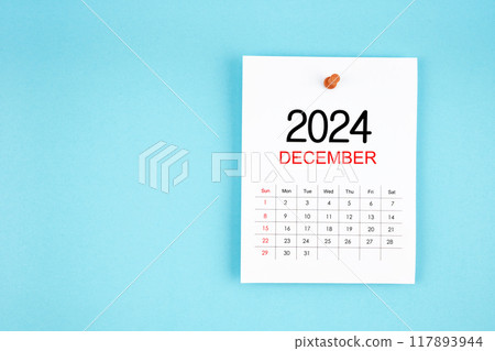 December 2024 calendar page with push pin on blue background. December 2024 calendar page with push pin on blue background. 117893944