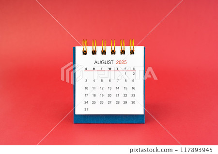 August 2025 white desk calendar on red background. August 2025 white desk calendar on red background. 117893945