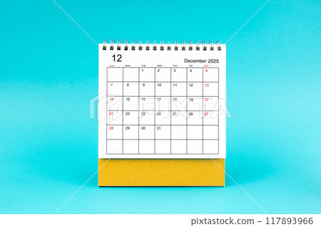 December 2025 desk calendar on blue background. December 2025 desk calendar on blue background. 117893966