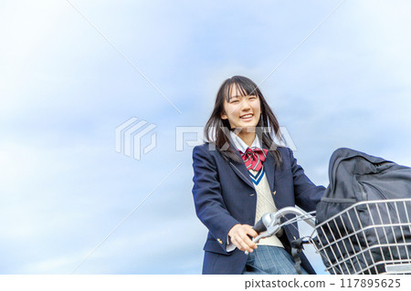 Schoolgirls commuting by bicycle 117895625