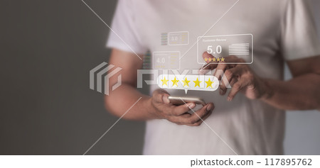 Customer Review, Young Man hand using smartphone mobile touch five star to review and give 5 stars  117895762