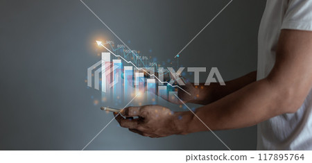 Young man hand using smartphone to visualize money growth The phone screen displays graphs  117895764