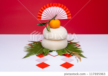 A photo of a real rice cake, "Kagami-mochi," in the center, on a red and white background, without a sanpo (pedestal) 117895963