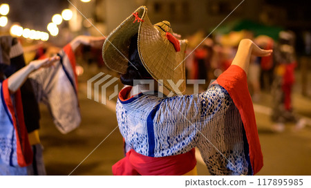 Women dancing in indigo-dyed yukata and woven straw hats at the Nishimonai Bon Odori Festival in 2024 in Akita Prefecture 117895985