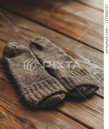 Warm woolen socks stacked on a rustic wood background winter accessory 117896201