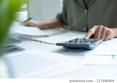Businesswoman sitting at desk on couch in workplace or 117896404