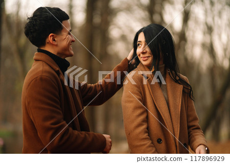 Young couple in love walking in the park on a autumn day. Enjoying time together. 117896929