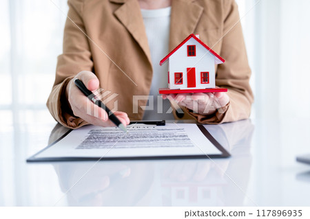 Real estate agent negotiating contract with buyer. Real estate agent negotiating contract with buyer. 117896935