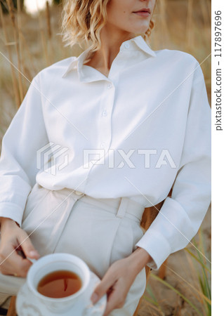 Stylish woman enjoying autumn weather outdoor. Fashion, style concept. People, lifestyle, relaxation Stylish woman enjoying autumn weather outdoor. Fashion, style concept. People, lifestyle, relaxation 117897696