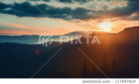 The setting sun is casting warm light and long shadows over the peaks and valleys of the carpathian mountains, creating a serene and awe-inspiring scene 117897824
