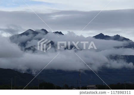 Mount Jigatake and Mount Kashima-Yari in the Northern Alps covered in clouds 117898311