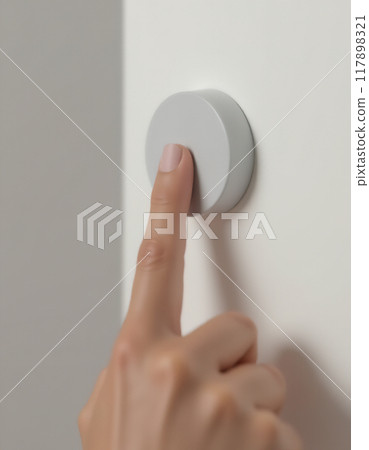 Hand pressing a switch button 117898321